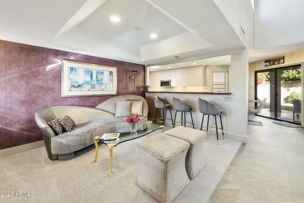 a living room with furniture and ceiling fan