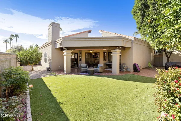 a view of a house with backyard porch and sitting area