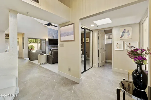 a living room with furniture and flowers