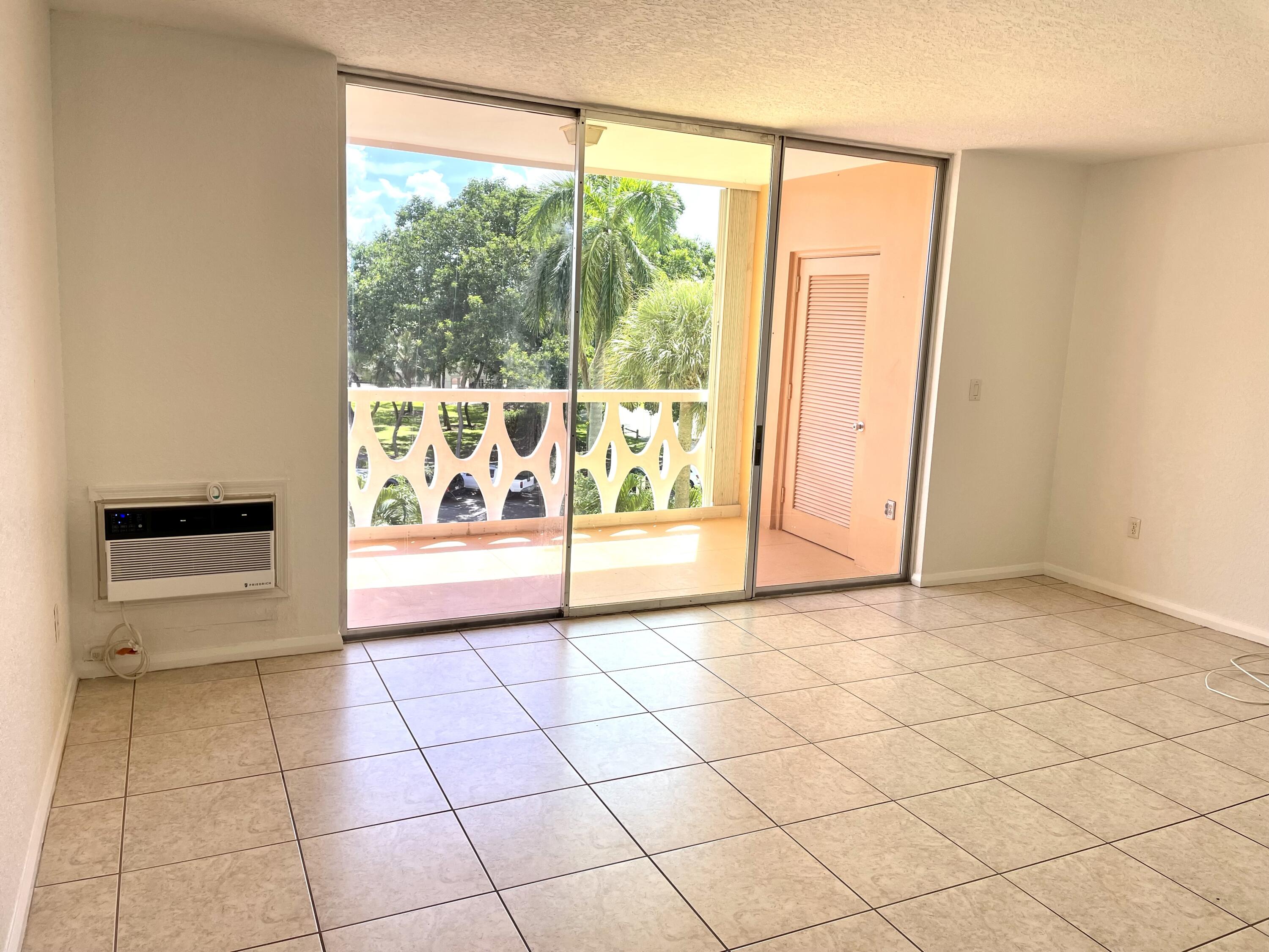 15 South Golfview Road, Unit 403 Lake Worth Beach, FL 33460 - Photo 19 of 32 a view of an empty room with a window