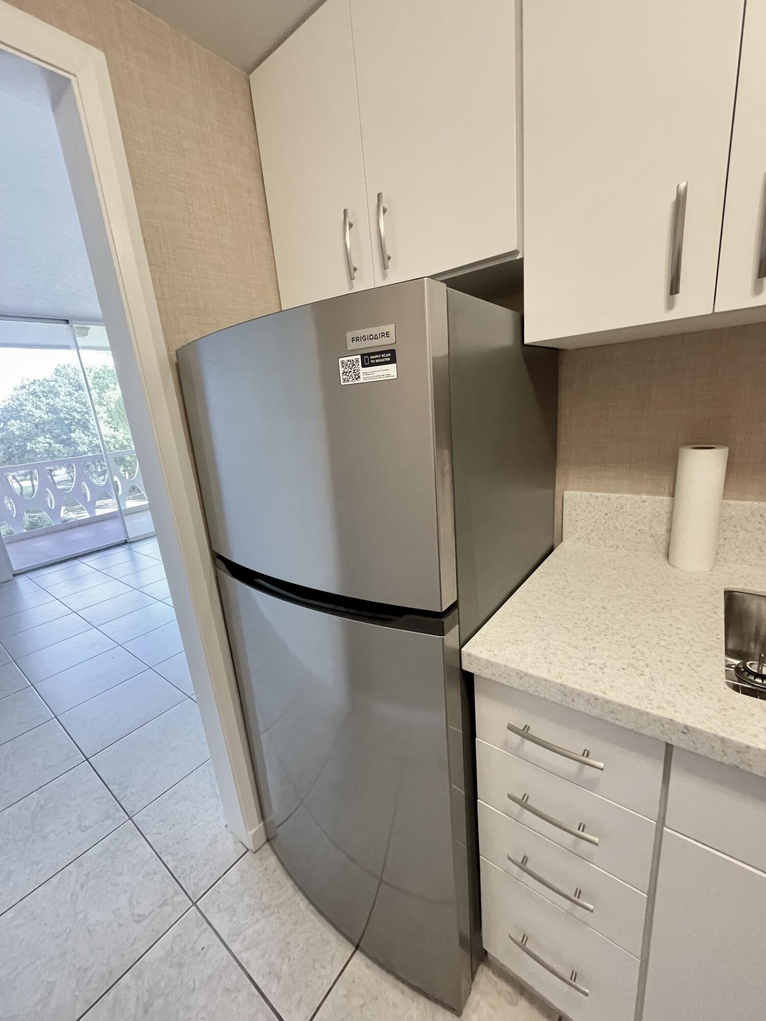 15 South Golfview Road, Unit 403 Lake Worth Beach, FL 33460 - Photo 29 of 32 a view of a refrigerator in kitchen and a window