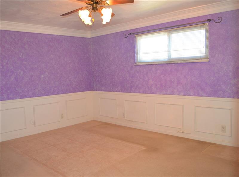 200 Olympic Road Pittsburgh, PA 15236 - Photo 14 of 25 Large, master bedroom featuring wainscoting and crown molding.