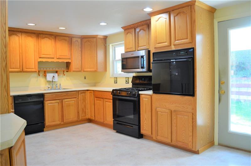 200 Olympic Road Pittsburgh, PA 15236 - Photo 4 of 25 Newly remodeled, eat in kitchen featuring oak cabinetry and a french door leading out to the covered back patio.