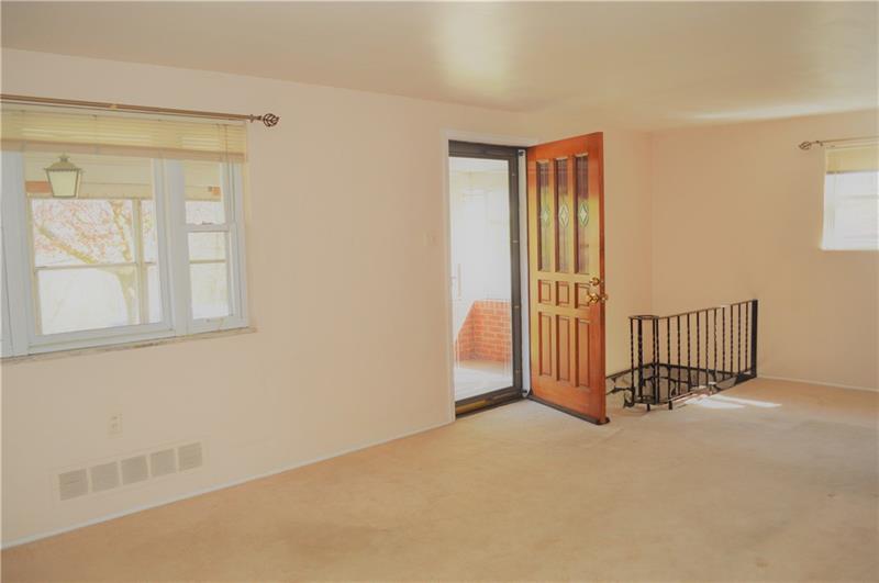 200 Olympic Road Pittsburgh, PA 15236 - Photo 7 of 25 Spacious living room/dining space with original hardwood under the carpet.