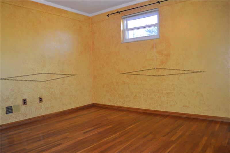 200 Olympic Road Pittsburgh, PA 15236 - Photo 10 of 25 Large, multi purpose room on the main floor with beautifully exposed hardwood flooring. This room can be utilized as an extra bedroom, dining area or even a large home office.