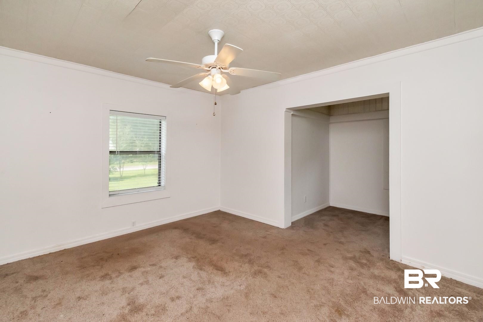 12751 Zanzibar Road Grand Bay, AL 36541 - Photo 14 of 30 Unfurnished bedroom with ceiling fan, carpet, a closet, and ornamental molding
