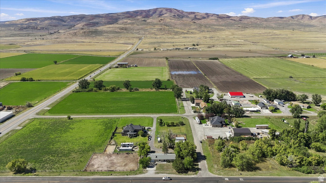15295 North 5400th Street West Riverside, UT 84334 - Photo 47 of 54 Expansive agricultural land featuring cultivated fields and scattered buildings