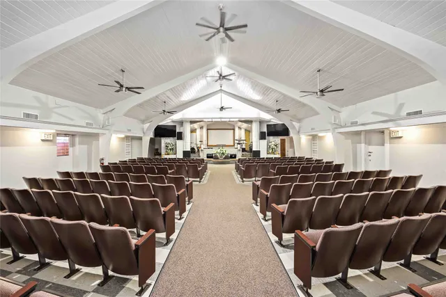 a living room with furniture a chandelier and a rug