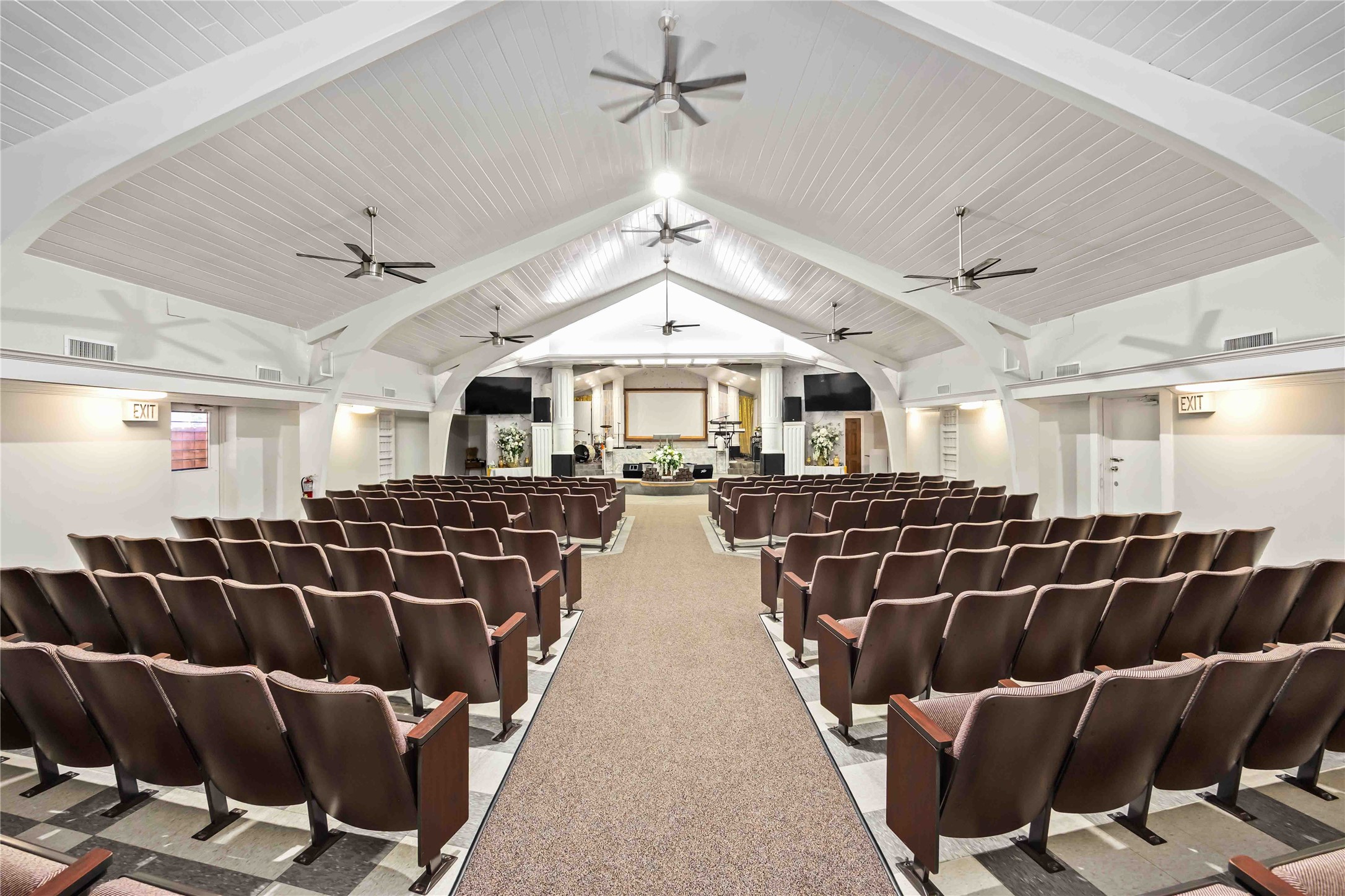 a living room with furniture a chandelier and a rug