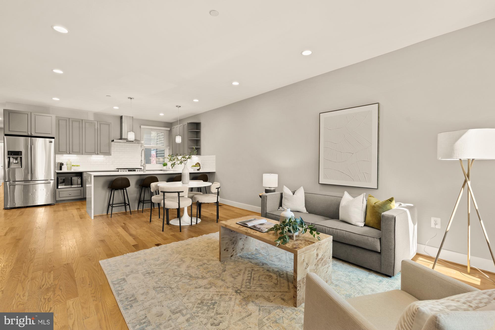 a living room with furniture and kitchen view