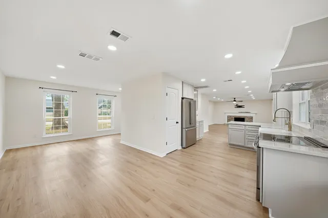 a view of a backyard with a garden and tree