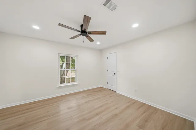 wooden floor in an empty room with a window