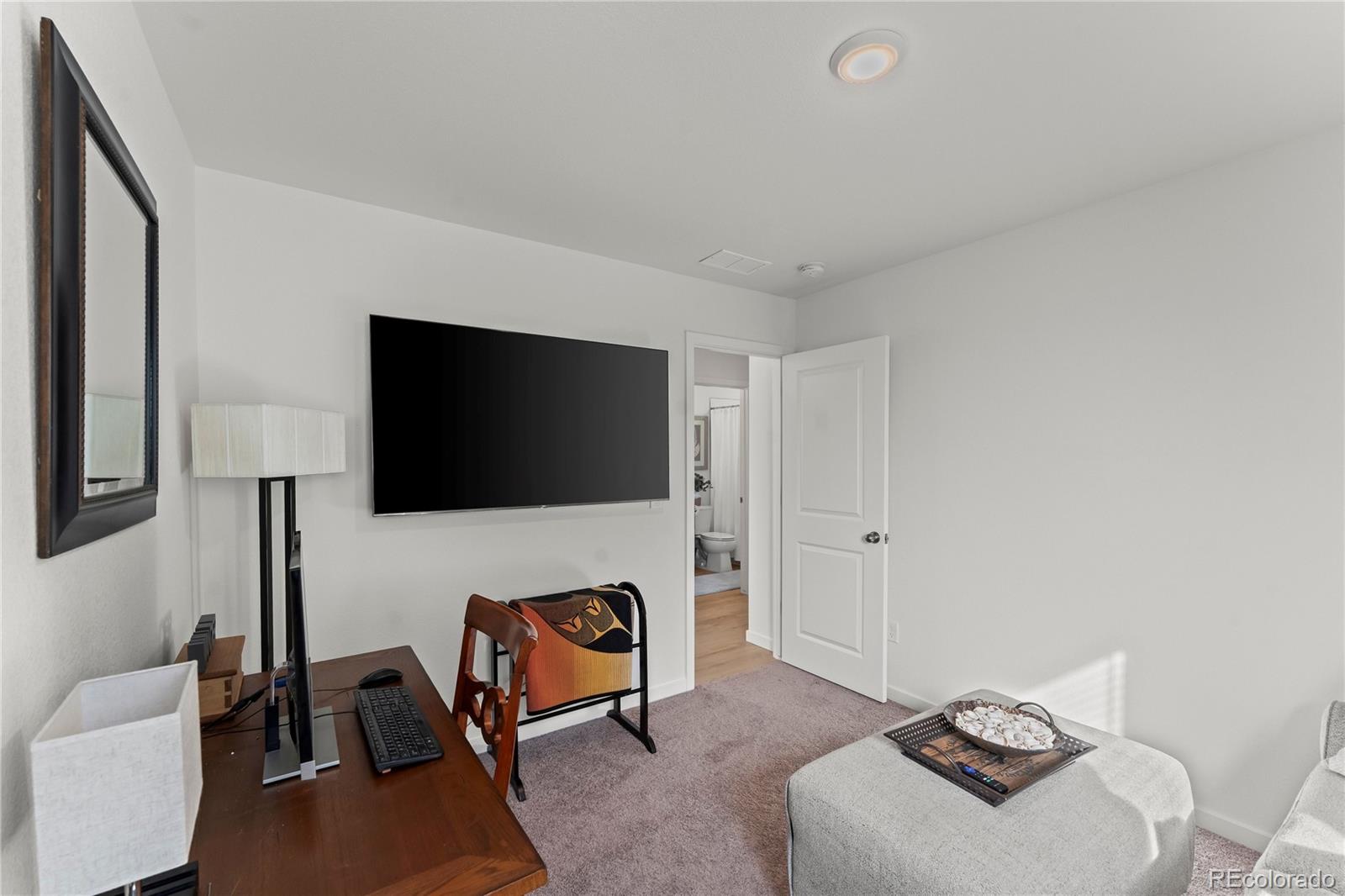 6355 Laud Point Colorado Springs, CO 80924 - Photo 15 of 32 a living room with furniture and a flat screen tv