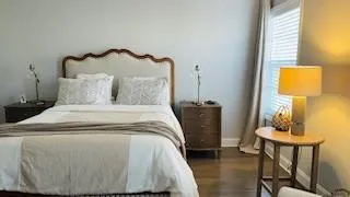 a bed sitting in a bedroom next to a window