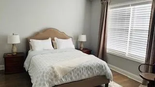 a bedroom with a bed and a window