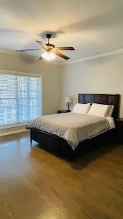 a bedroom with a bed and a ceiling fan