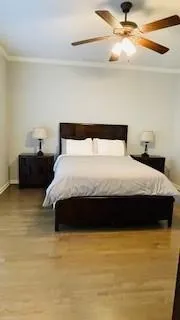 a large bed sitting in a bedroom next to a window