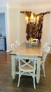 a close view of dining table chairs and a stove