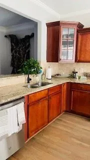 a kitchen with stainless steel appliances granite countertop a sink stove and cabinets
