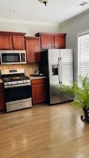 a kitchen with stainless steel appliances a stove a microwave and a refrigerator
