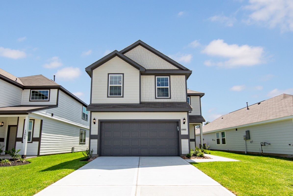 a front view of a house with a yard and garage