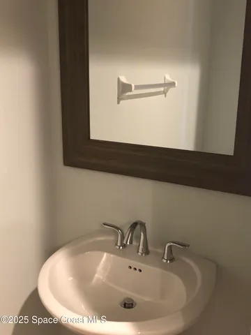 a bathroom with a sink and mirror