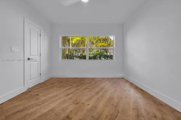 a view of an empty room with a window