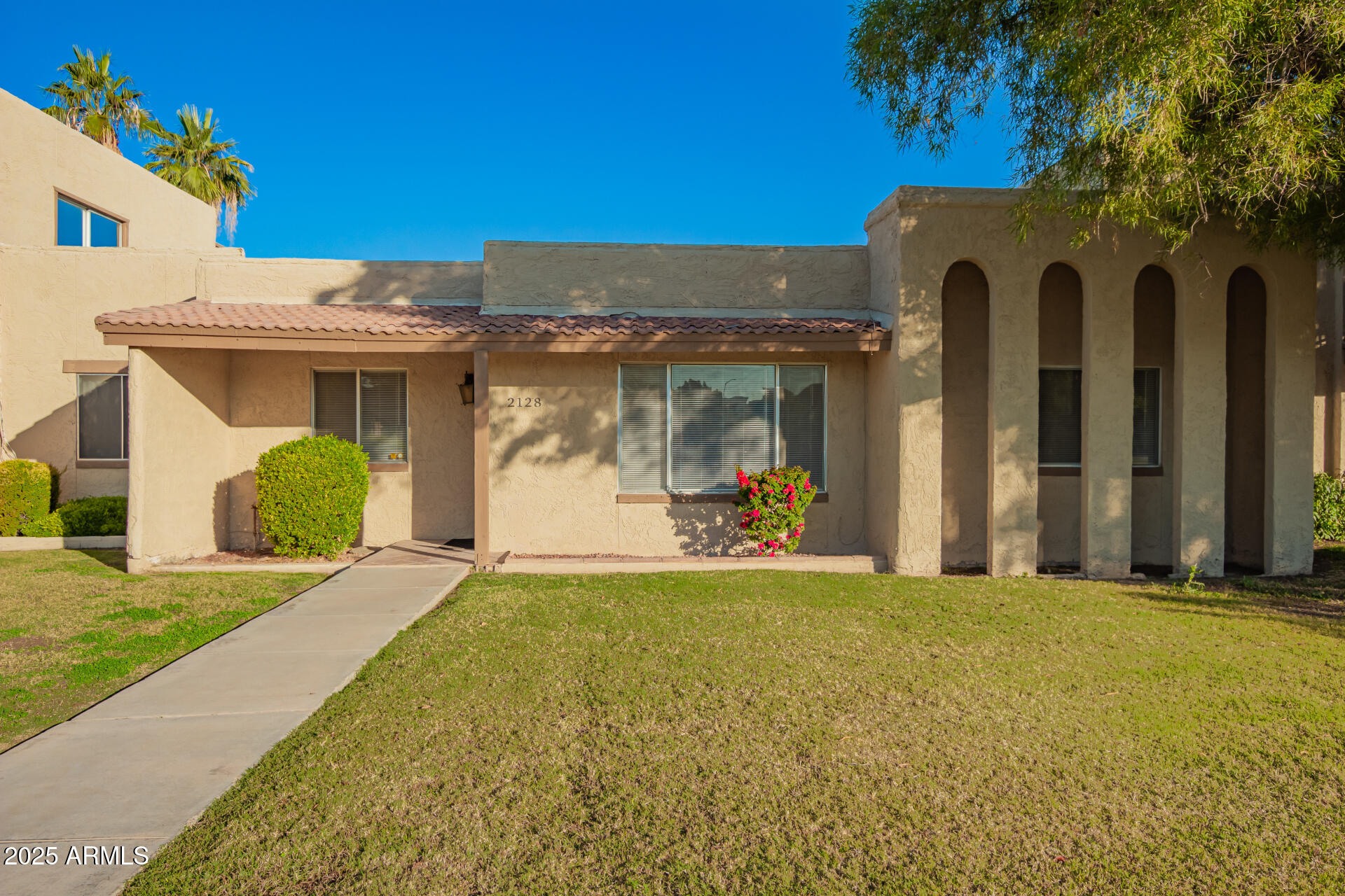 2128 East Villa Court Tempe, AZ 85282 - Photo 1 of 32 a front view of a house with a yard and garage