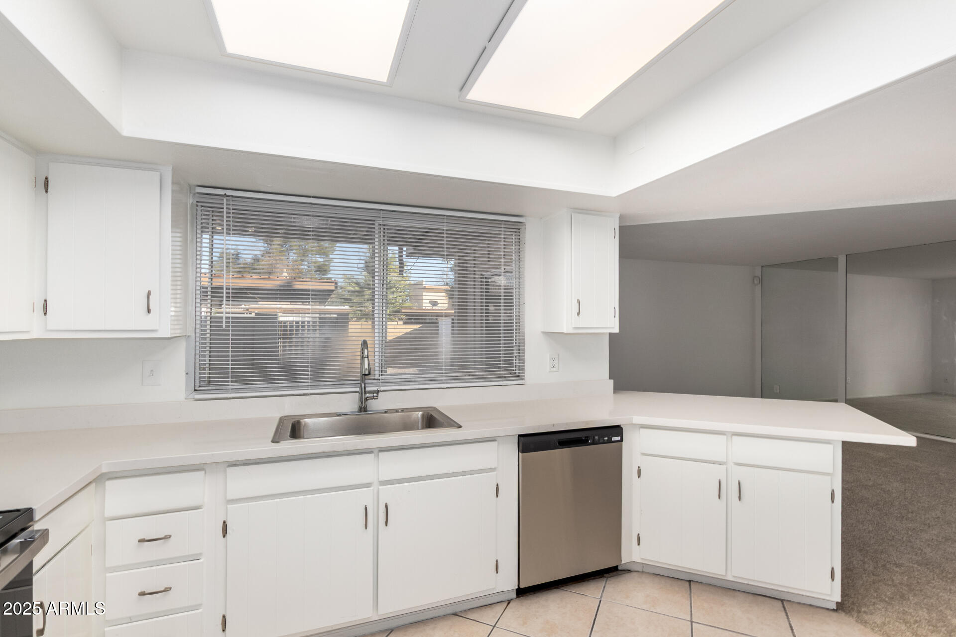 2128 East Villa Court Tempe, AZ 85282 - Photo 11 of 32 a kitchen with white cabinets and sink