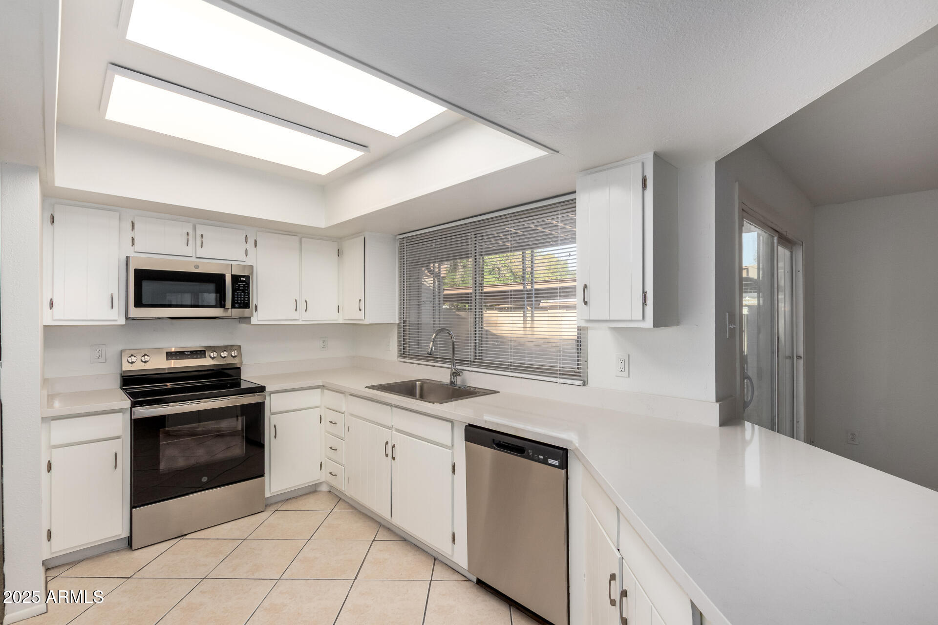 2128 East Villa Court Tempe, AZ 85282 - Photo 12 of 32 a kitchen with stainless steel appliances granite countertop a sink and a stove