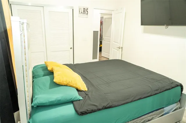 a bed sitting in a bedroom next to a window