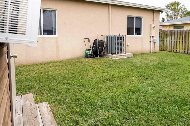 a view of a house with backyard and porch