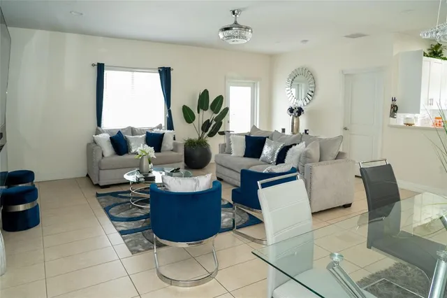 a living room with furniture and a chandelier