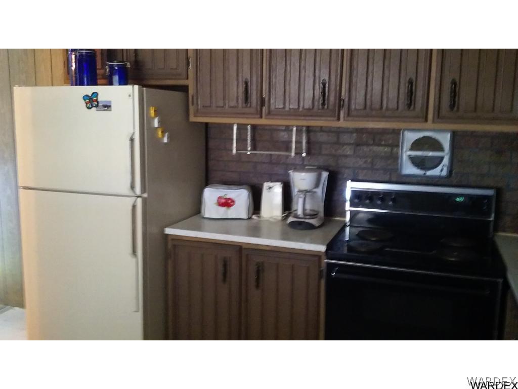 3681 Bosque Road Golden Valley, AZ 86413 - Photo 12 of 17 a kitchen with a refrigerator and a stove top oven