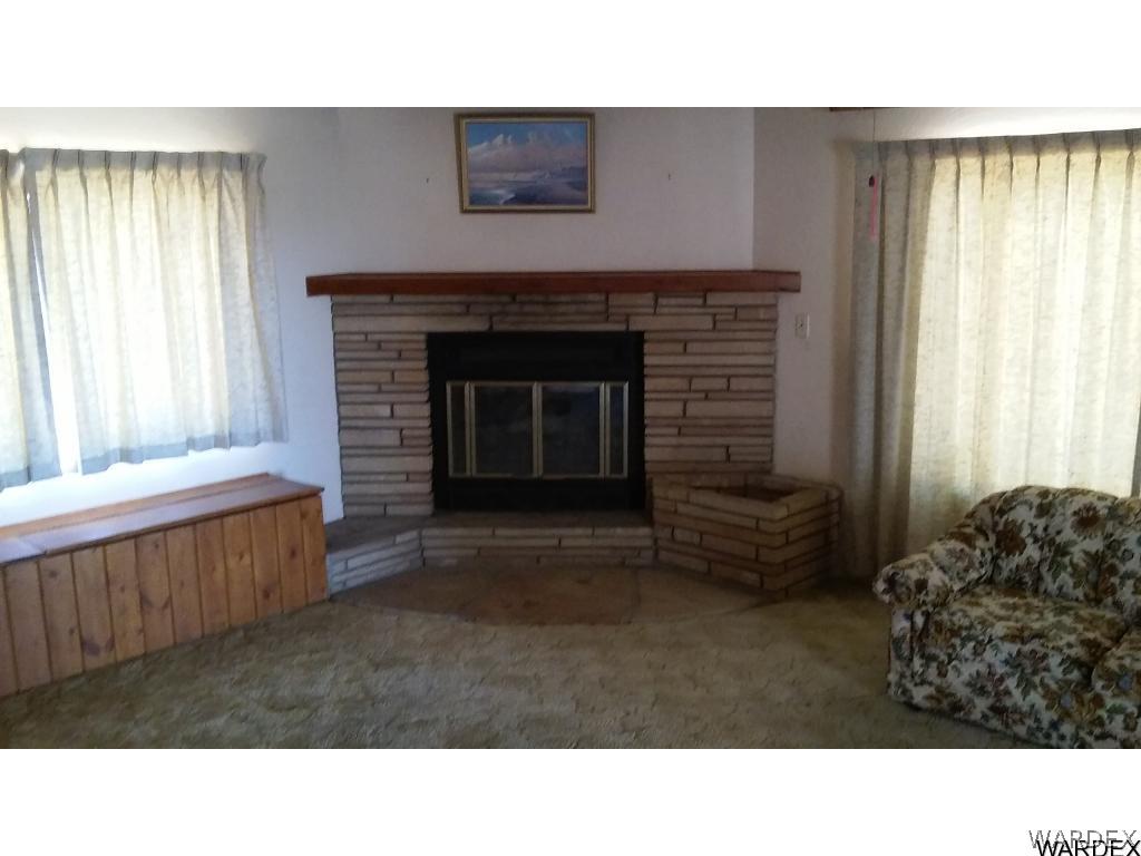 3681 Bosque Road Golden Valley, AZ 86413 - Photo 13 of 17 a living room with furniture and a fireplace