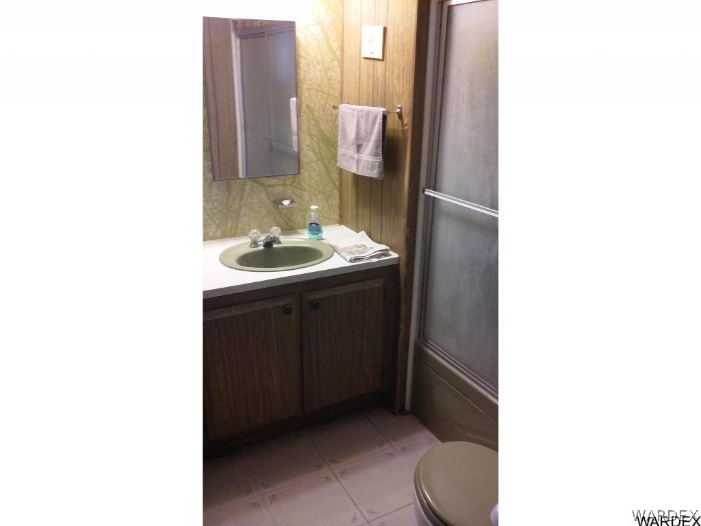 3681 Bosque Road Golden Valley, AZ 86413 - Photo 14 of 17 a bathroom with a sink and a toilet