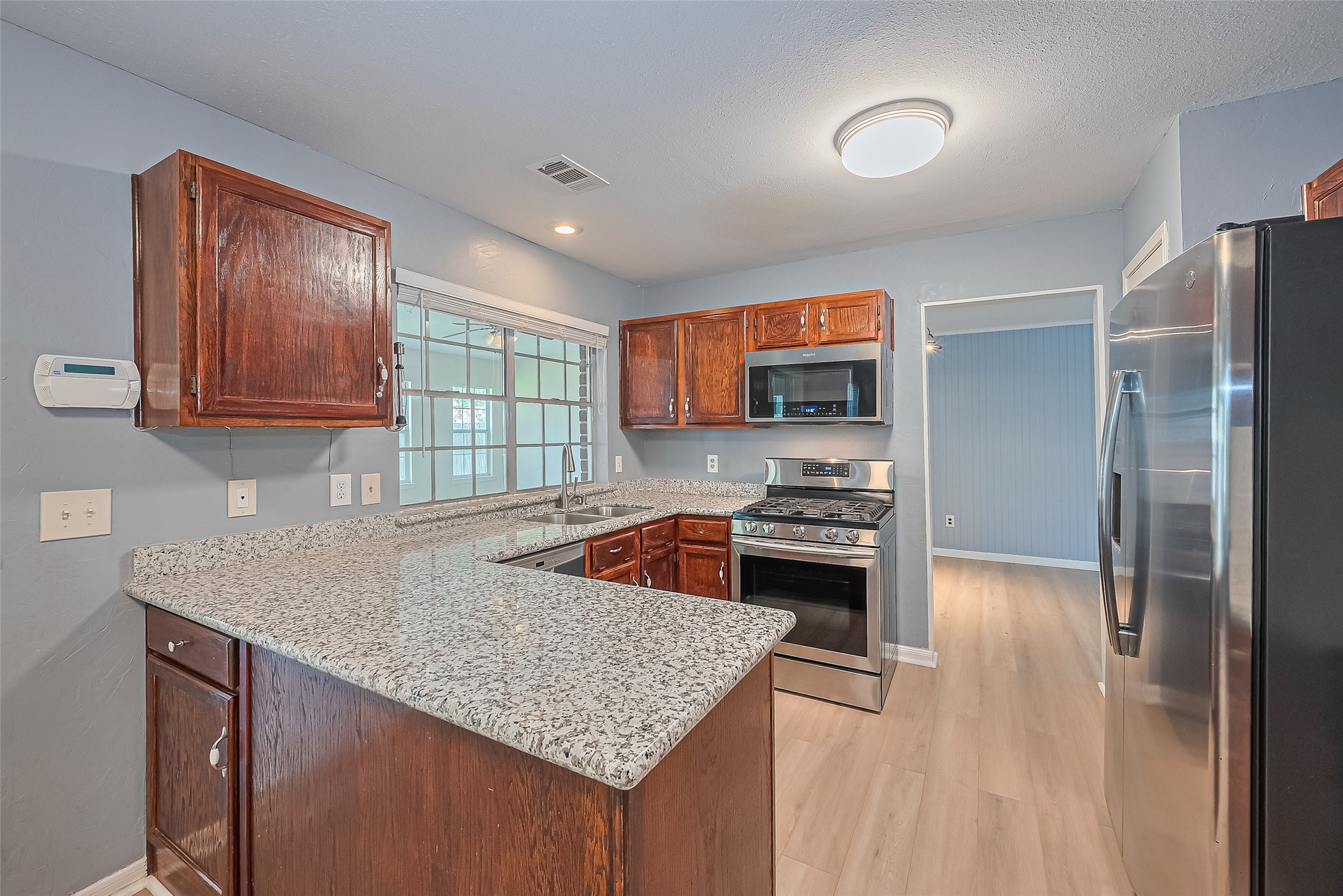1010 Cheyenne Meadows Drive Katy, TX 77450 - Photo 18 of 41 a kitchen with stainless steel appliances granite countertop a sink stove and refrigerator