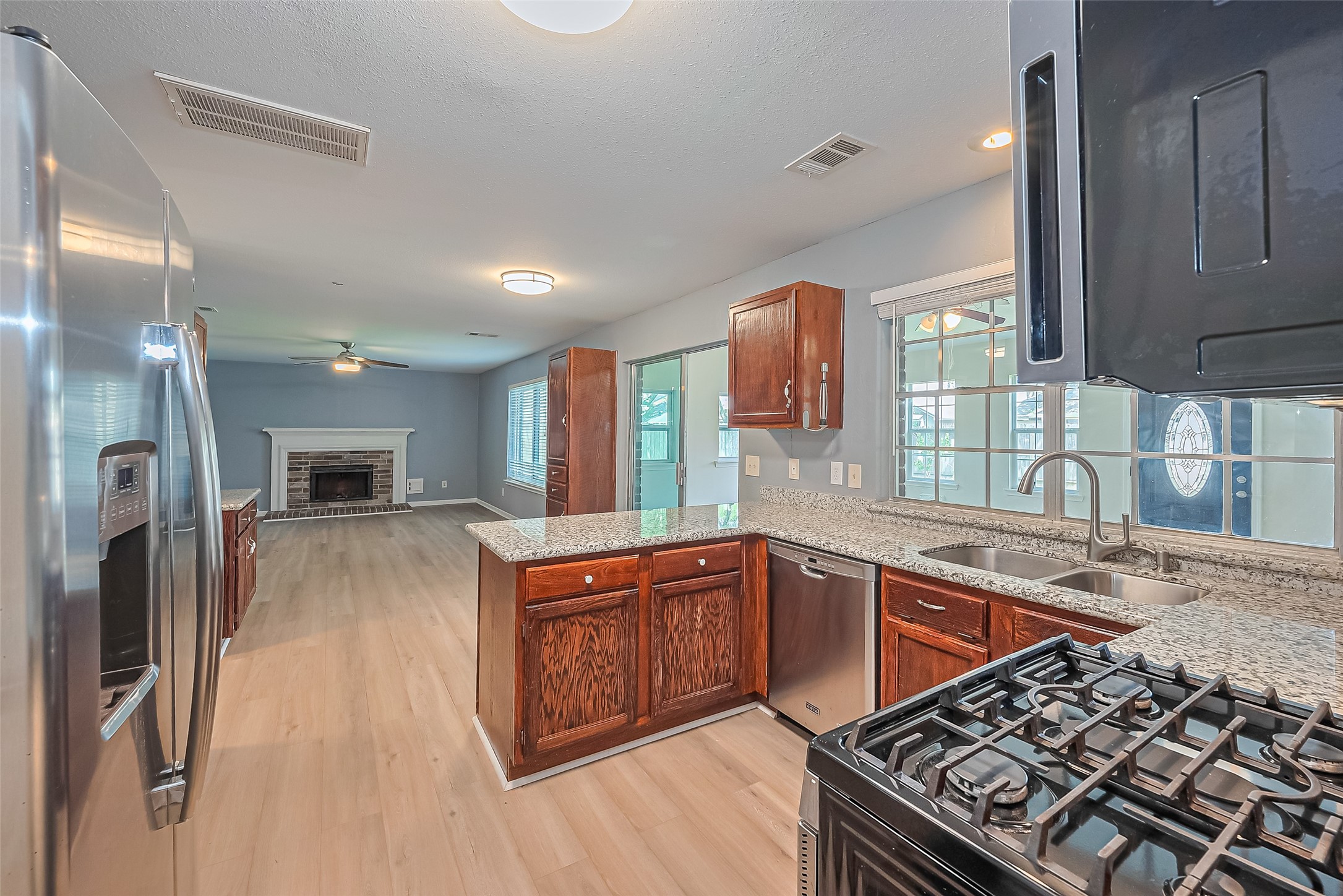 1010 Cheyenne Meadows Drive Katy, TX 77450 - Photo 19 of 41 a kitchen with stainless steel appliances granite countertop a sink stove and refrigerator