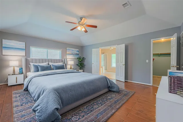 a bedroom with a large bed and a chandelier
