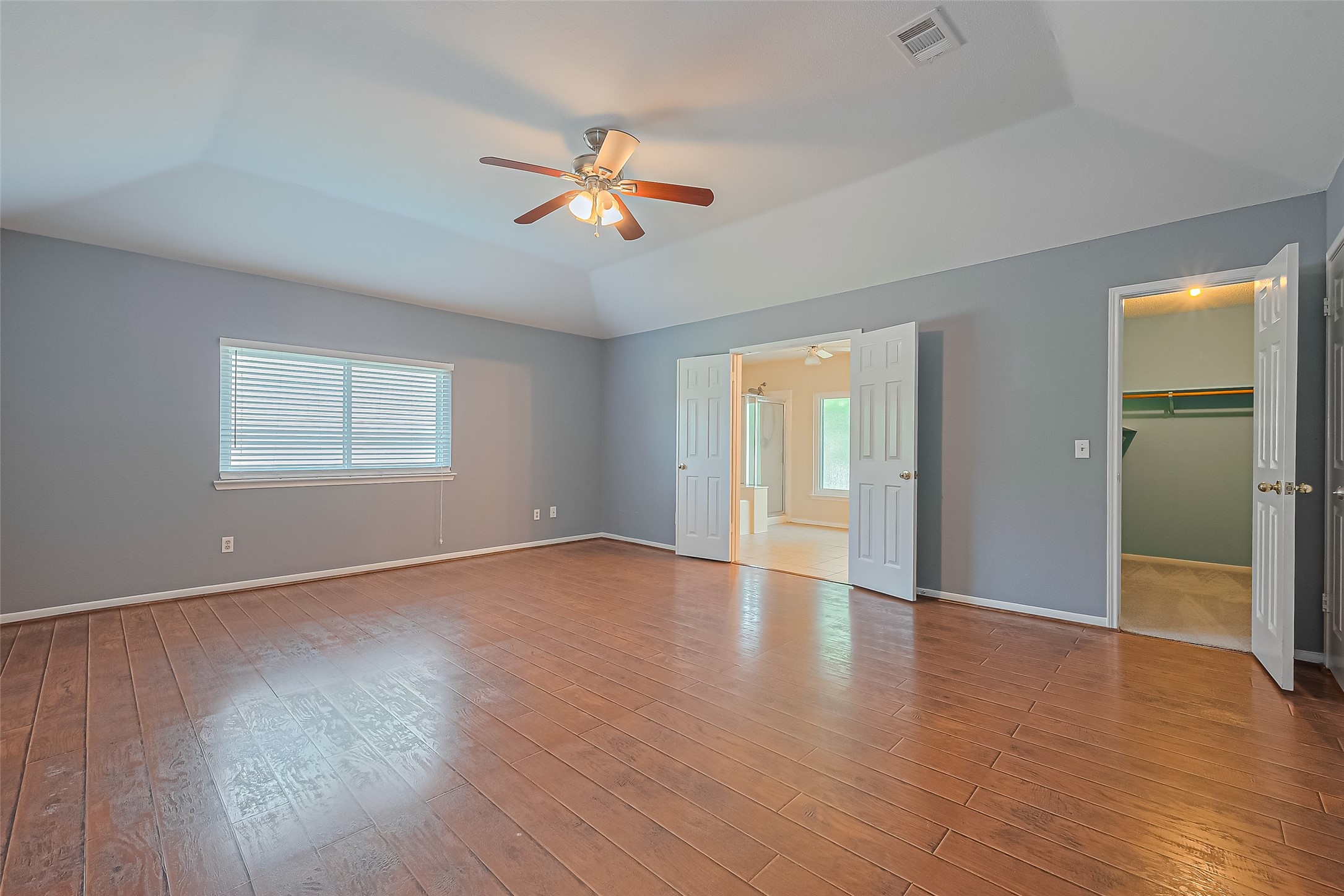 1010 Cheyenne Meadows Drive Katy, TX 77450 - Photo 25 of 41 an empty room with wooden floor chandelier and windows