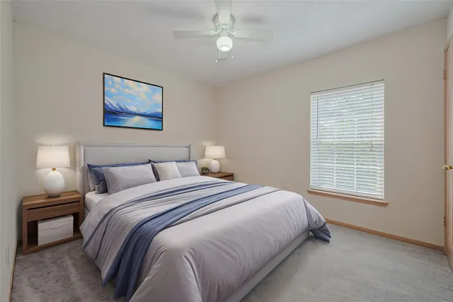 a bedroom with a bed and a night stand