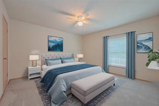 a bedroom with a bed and a painting on the wall