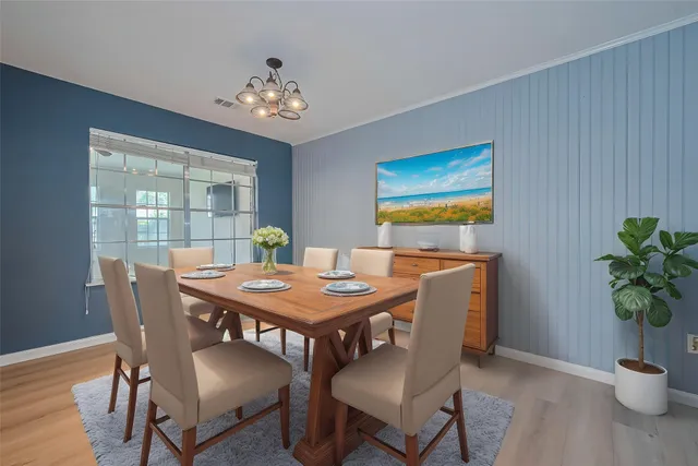 a view of a dining room with furniture window and wooden floor