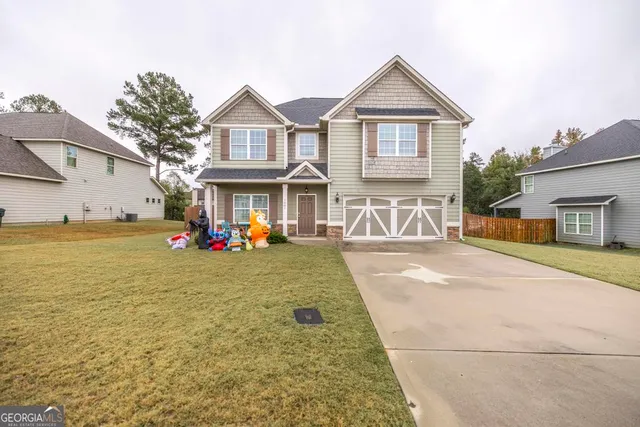 a front view of a house with a yard and garage