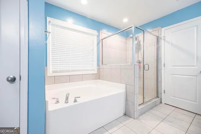 a bathroom with a bathtub and a shower
