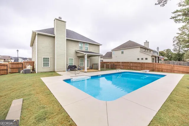 a view of a swimming pool with an outdoor space and seating area
