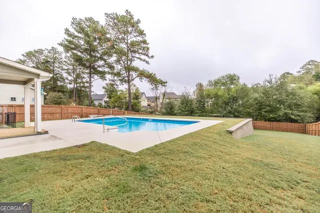 a view of swimming pool with outdoor seating and city view