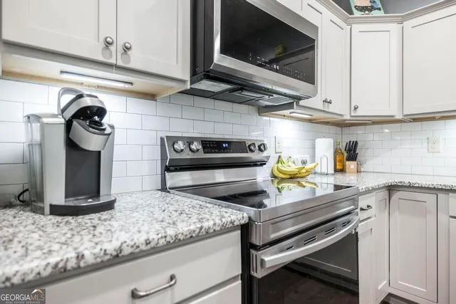 a kitchen with a stove and cabinets