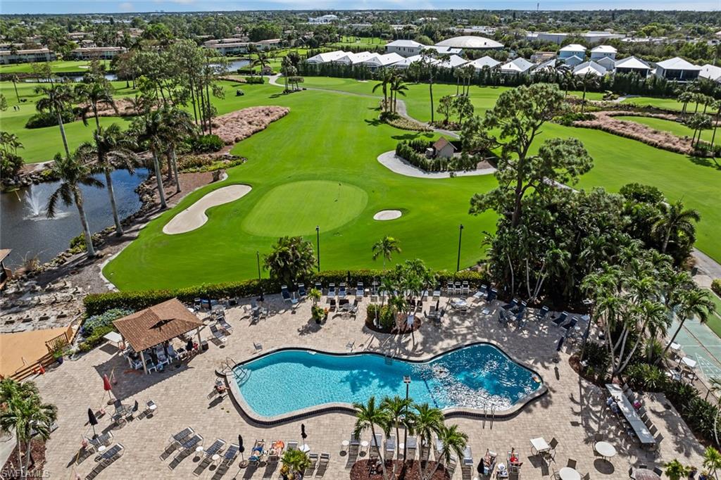 136 Harrison Road, Unit 1 Naples, FL 34112 - Photo 25 of 29 Resort-style pool area featuring a freeform pool, surrounding patio, and dedicated lounging spaces