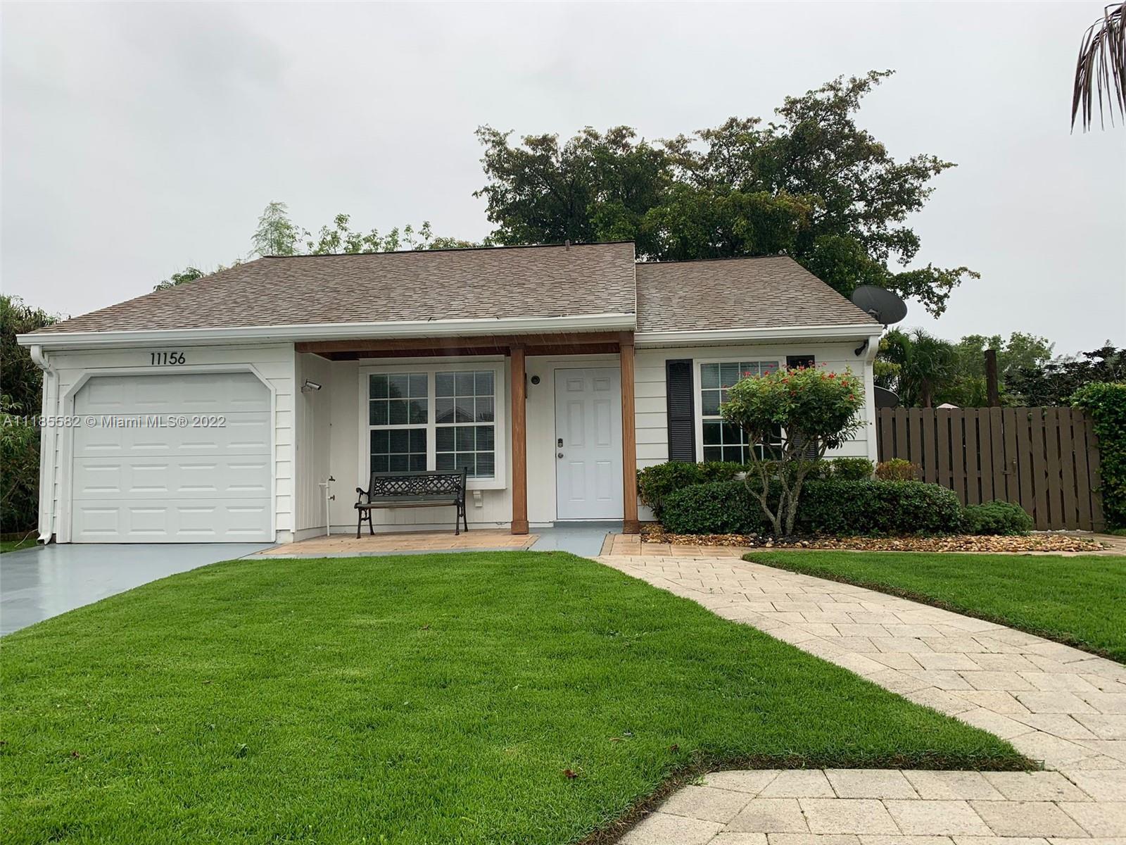 11156 Goss Lane Boca Raton, FL 33428 - Photo 1 of 20 a front view of a house with a yard and green space